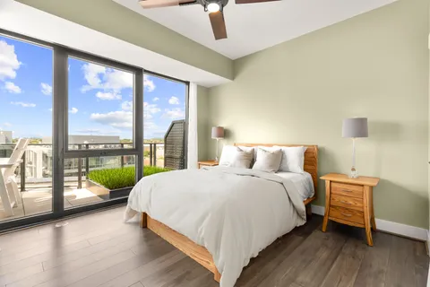 a bedroom with a bed and a large window with outer view