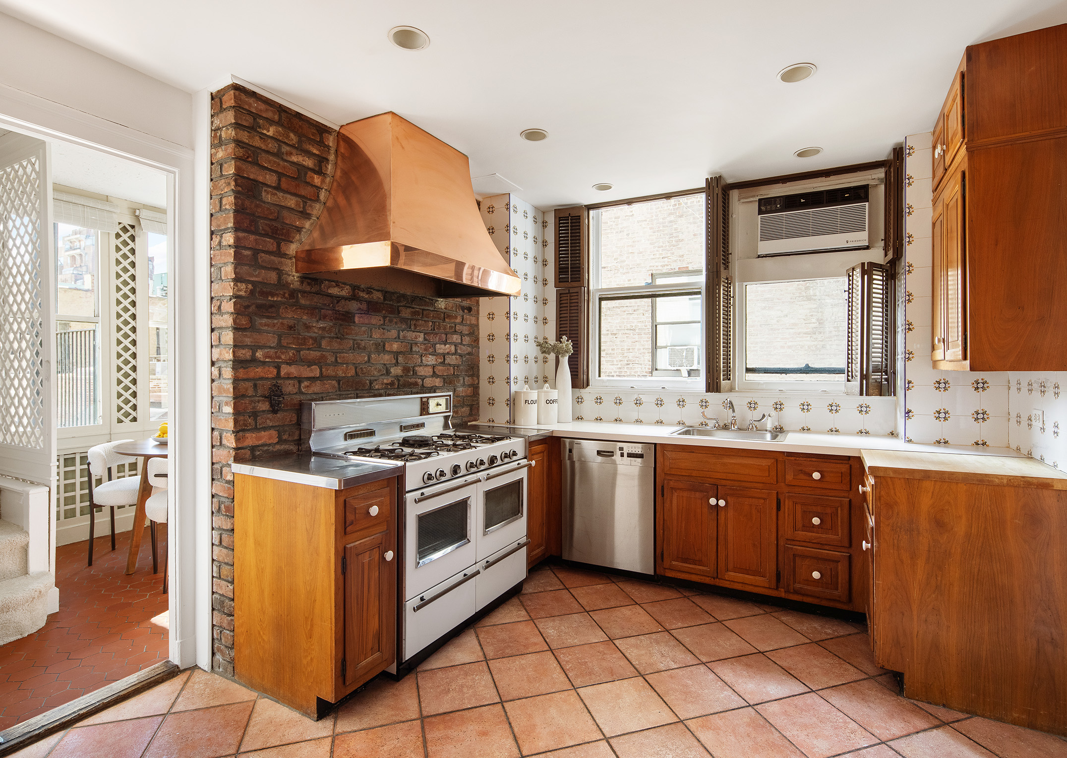 953 5th Avenue, Unit 7/8 Manhattan, NY 10075 - Photo 12 of 15 a kitchen with a stove top oven sink and cabinets