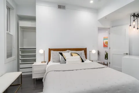 a bedroom with a bed and a chair