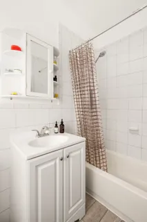 a bathroom with a sink toilet vanity and shower