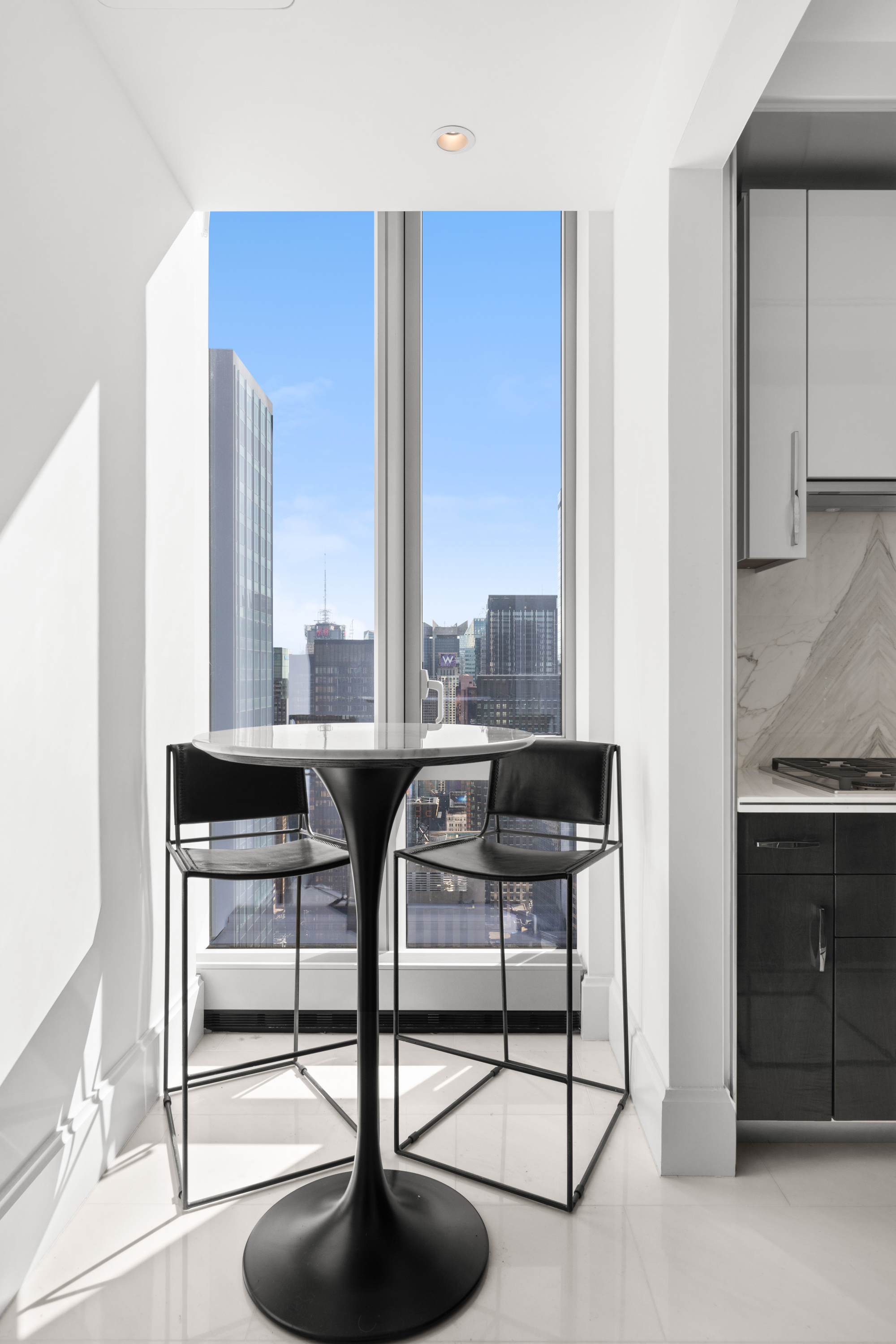 217 West 57th Street, Unit 48D Manhattan, NY 10019 - Photo 7 of 17 a view of a livingroom with furniture and window