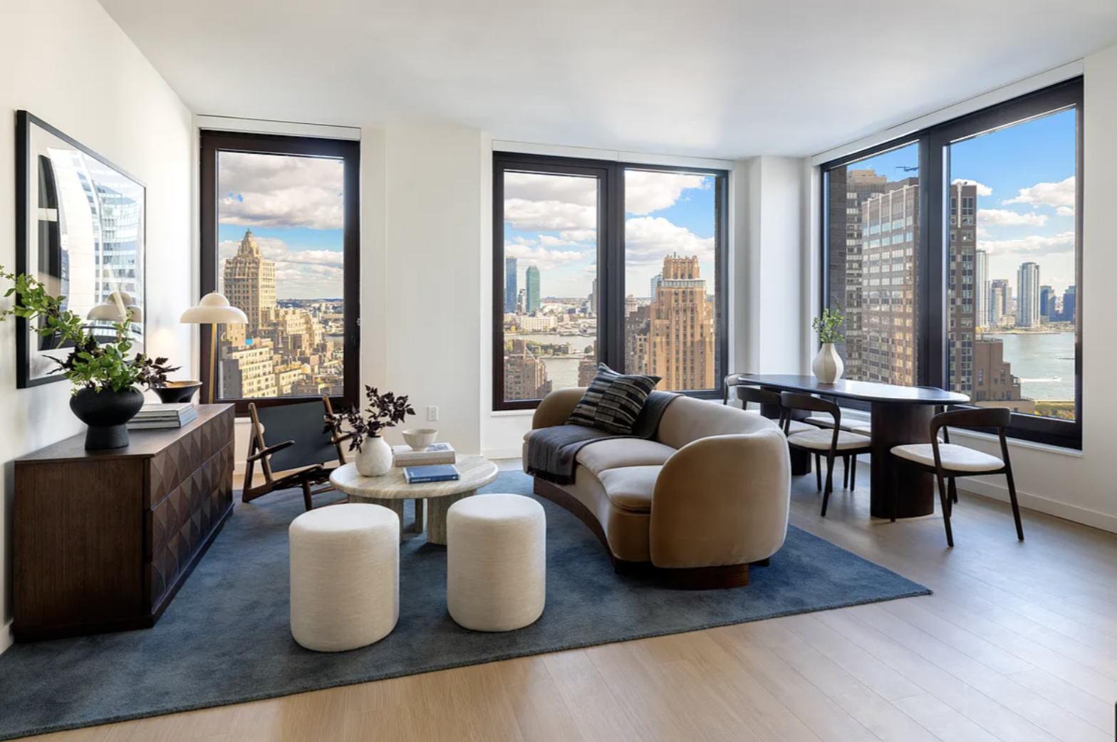 a living room with furniture and floor to ceiling windows