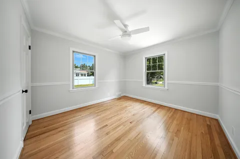 a view of empty room with wooden floor