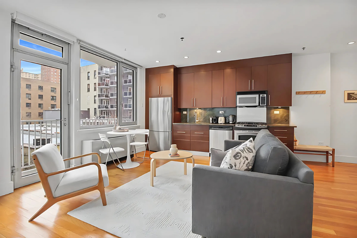 154 Attorney Street, Unit 304 Manhattan, NY 10002 - Photo 2 of 13 a living room with furniture and a large window