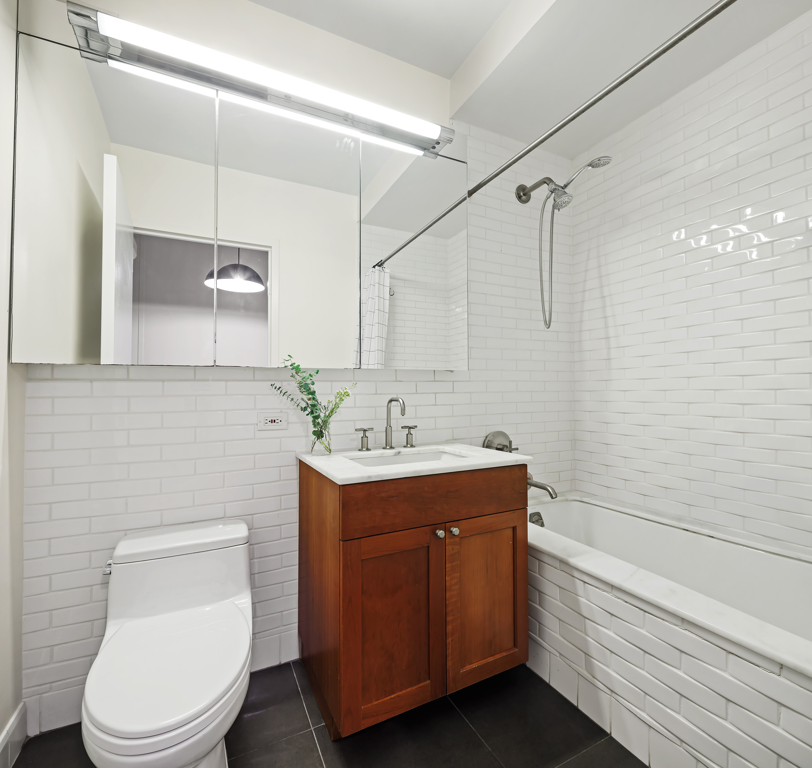9 College Place, Unit 2K Brooklyn, NY 11201 - Photo 6 of 17 a bathroom with a sink a toilet and shower