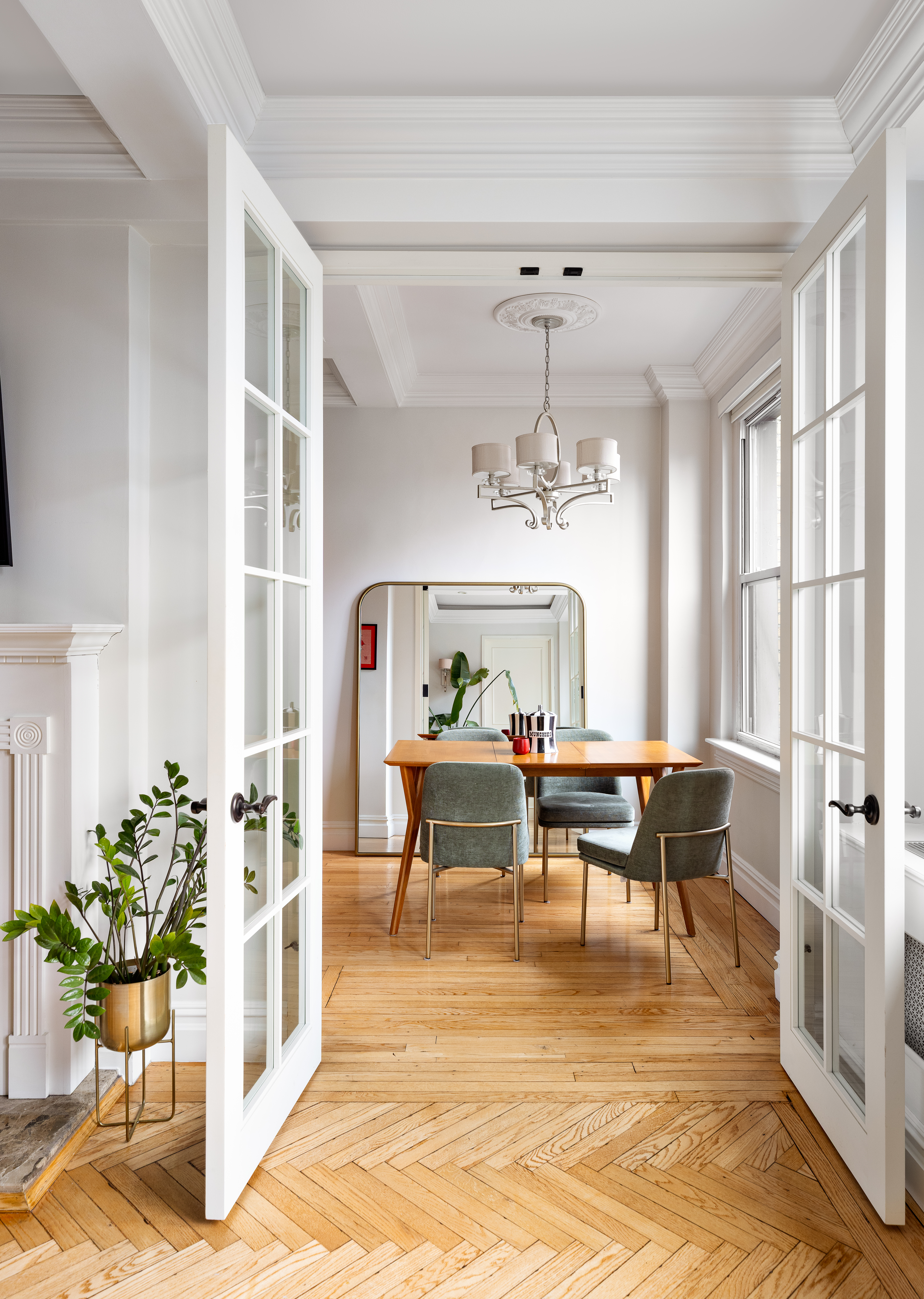 55 Park Avenue, Unit 9E Manhattan, NY 10016 - Photo 6 of 9 a living room with furniture a chandelier and a dining table
