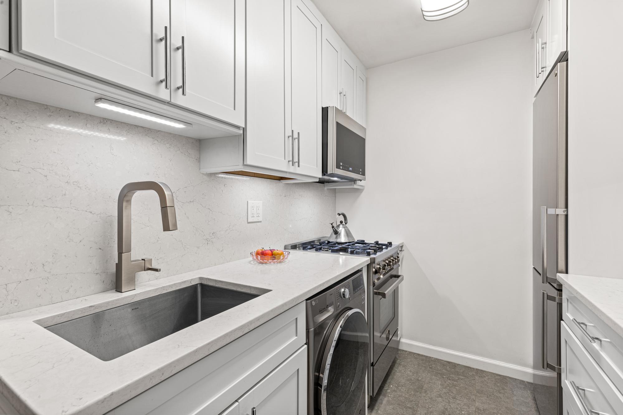2025 Broadway, Unit 5K Manhattan, NY 10023 - Photo 6 of 15 a view of a kitchen with sink washer and dryer