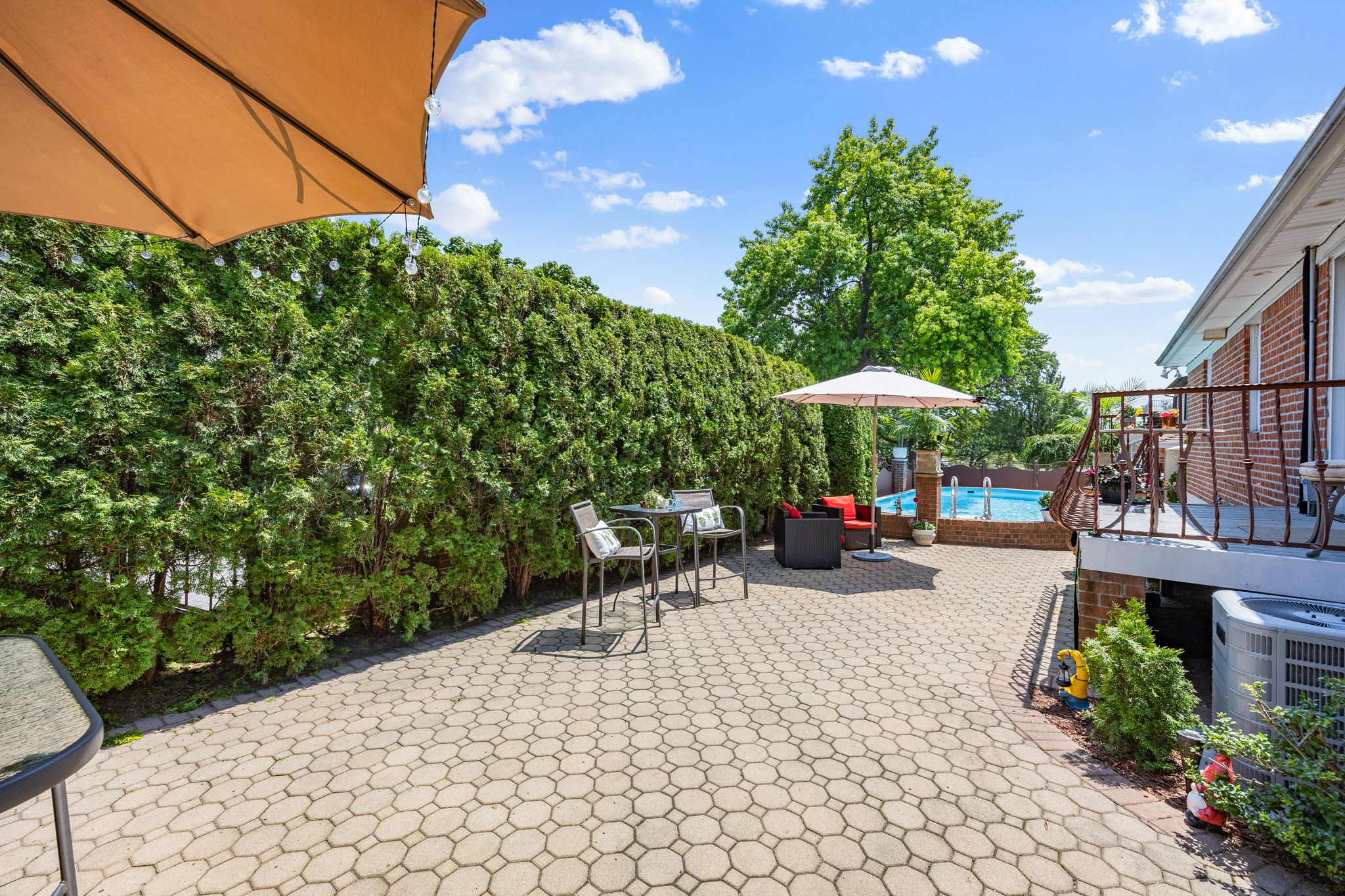 141-18 14th Avenue Queens, NY 11357 - Photo 16 of 26 a view of a patio with table and chairs under an umbrella