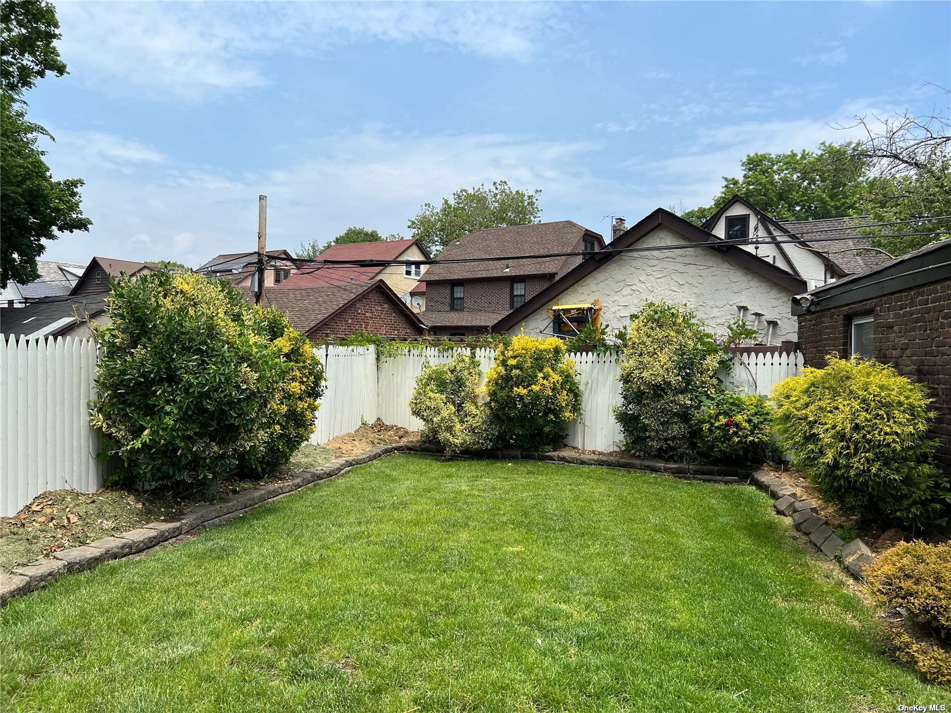 85-23 Edgerton Boulevard Queens, NY 11432 - Photo 30 of 36 a view of a garden with a house