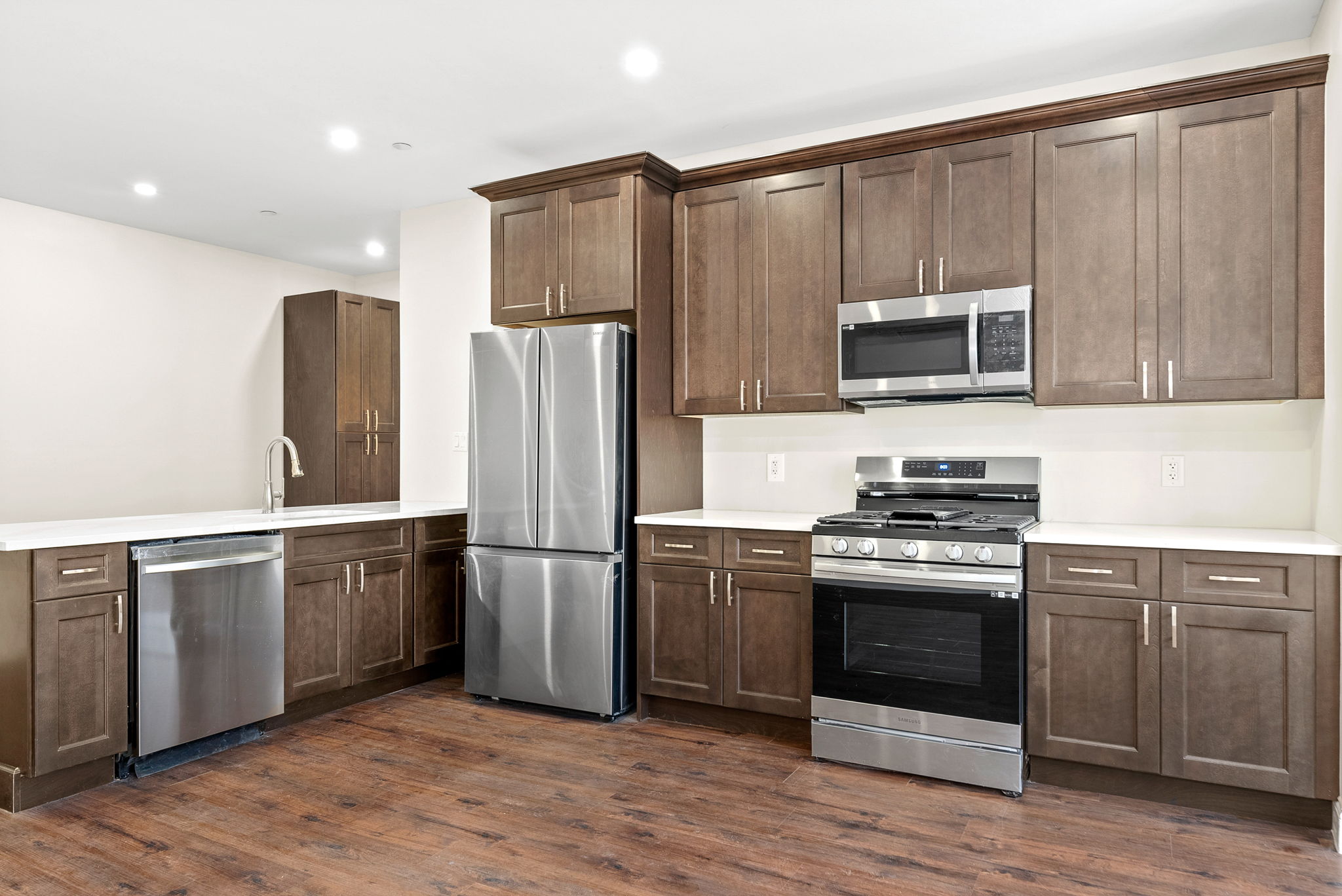 217 Butler Street, Unit 1 Brooklyn, NY 11217 - Photo 3 of 10 a kitchen with stainless steel appliances a stove a sink and a microwave