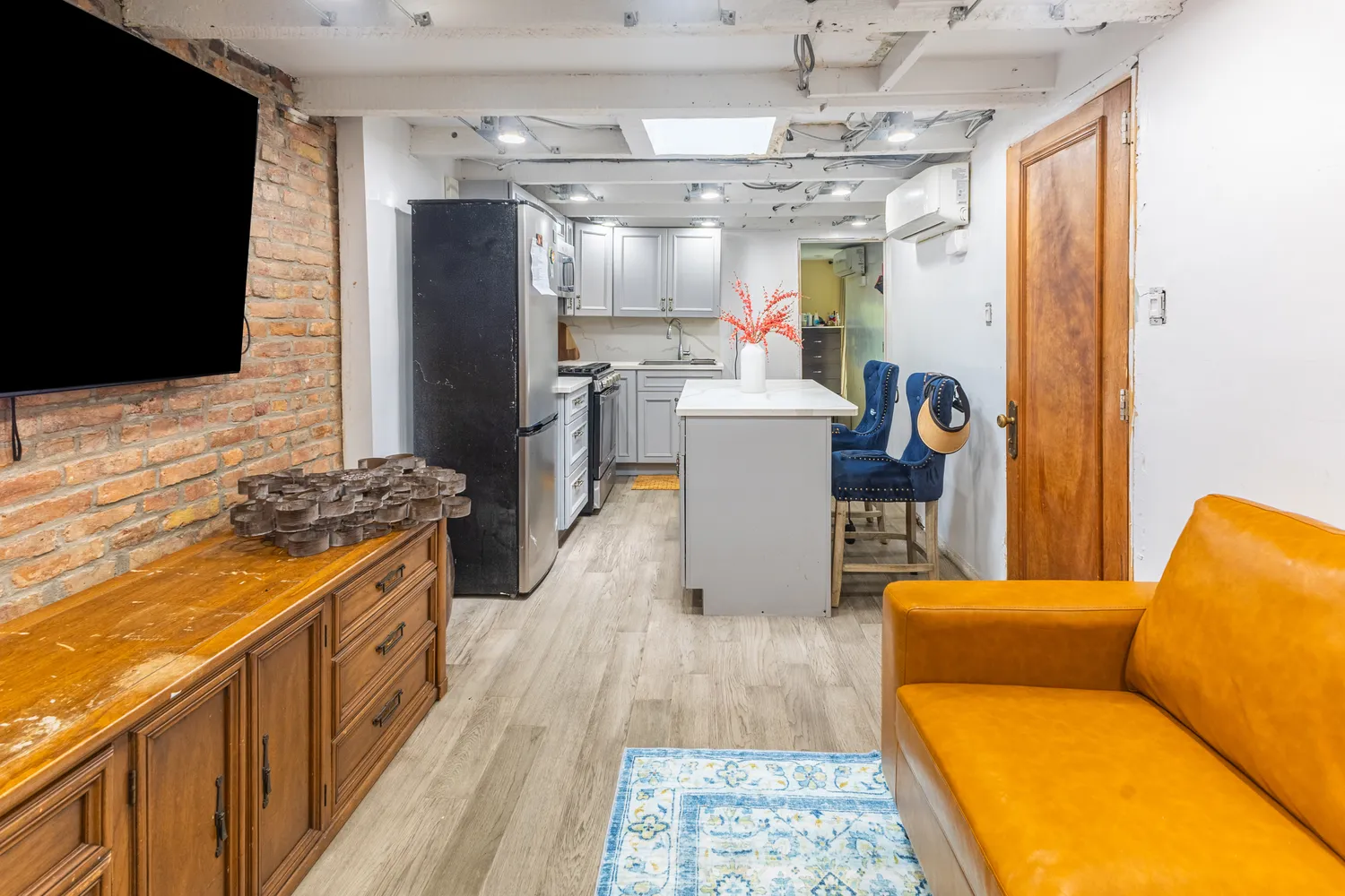 a kitchen with stainless steel appliances granite countertop a refrigerator a stove top oven a sink dishwasher and wooden cabinets