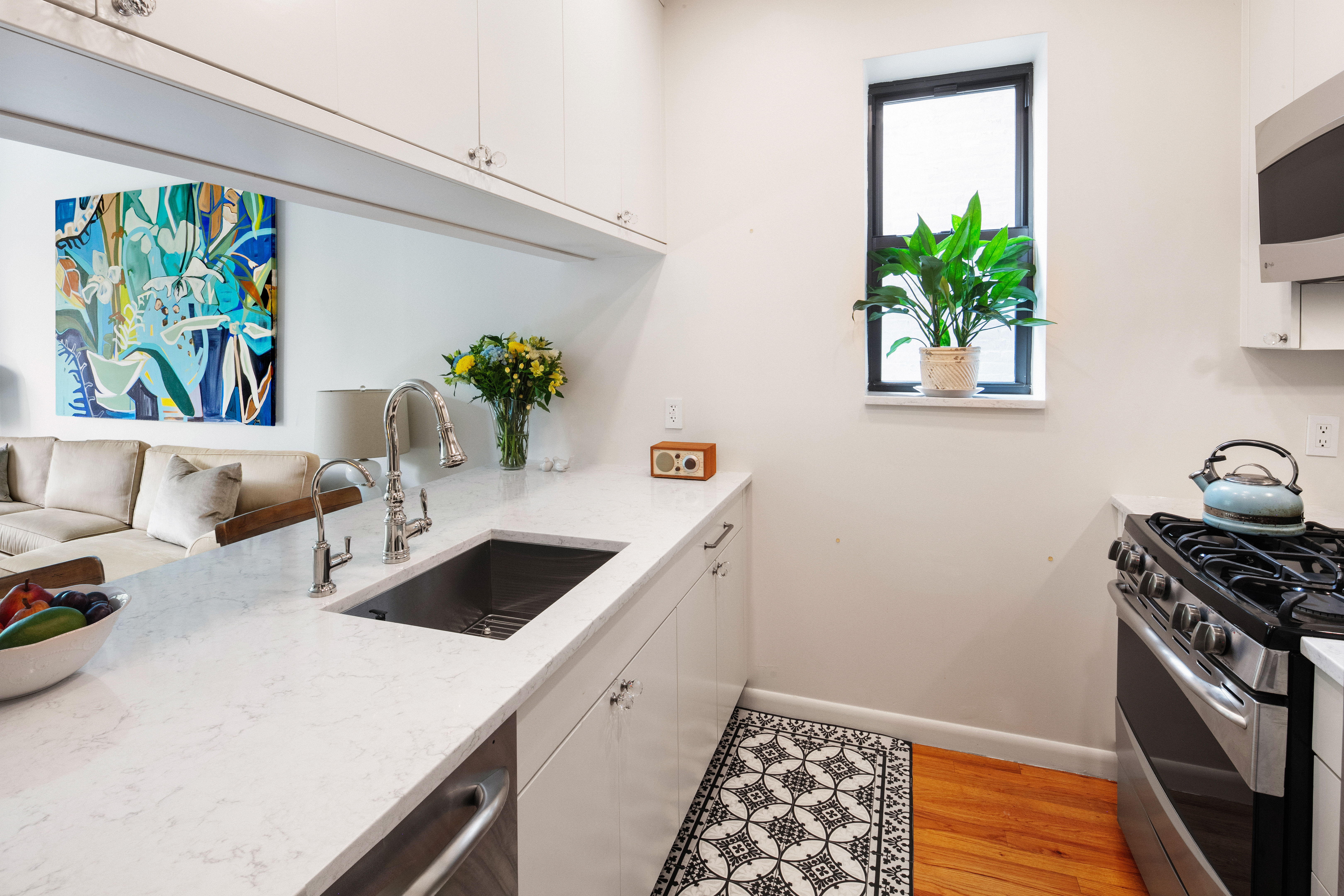 5 West 127th Street, Unit 3B Manhattan, NY 10027 - Photo 6 of 9 a kitchen with a sink and a stove top oven