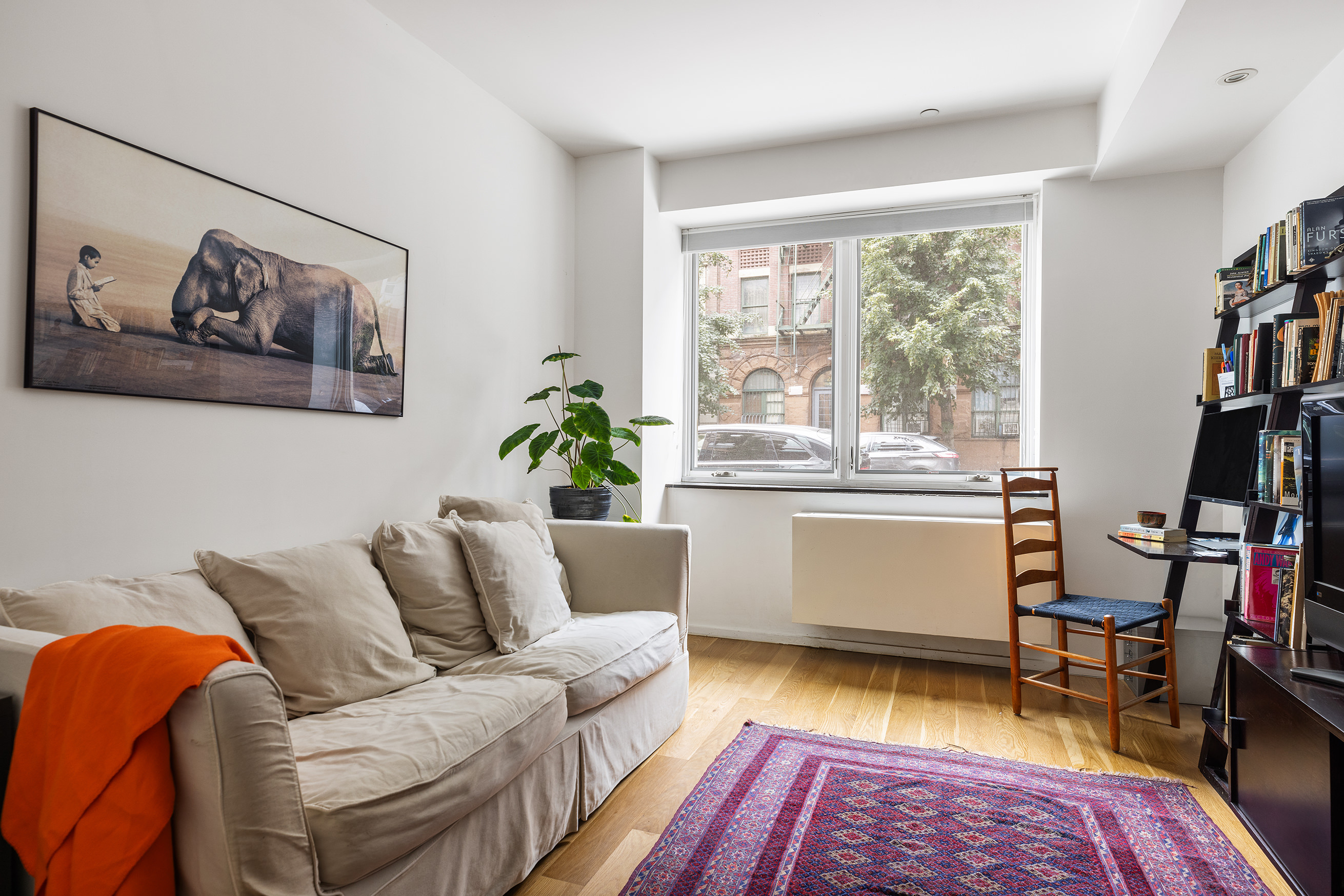 271 West 122nd Street, Unit A Manhattan, NY 10027 - Photo 6 of 19 a living room with furniture and a wooden floor