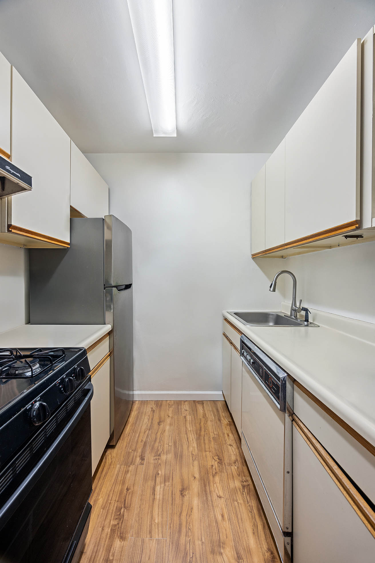 120 East 90th Street, Unit 7B Manhattan, NY 10128 - Photo 6 of 8 a kitchen with sink and stainless steel appliances