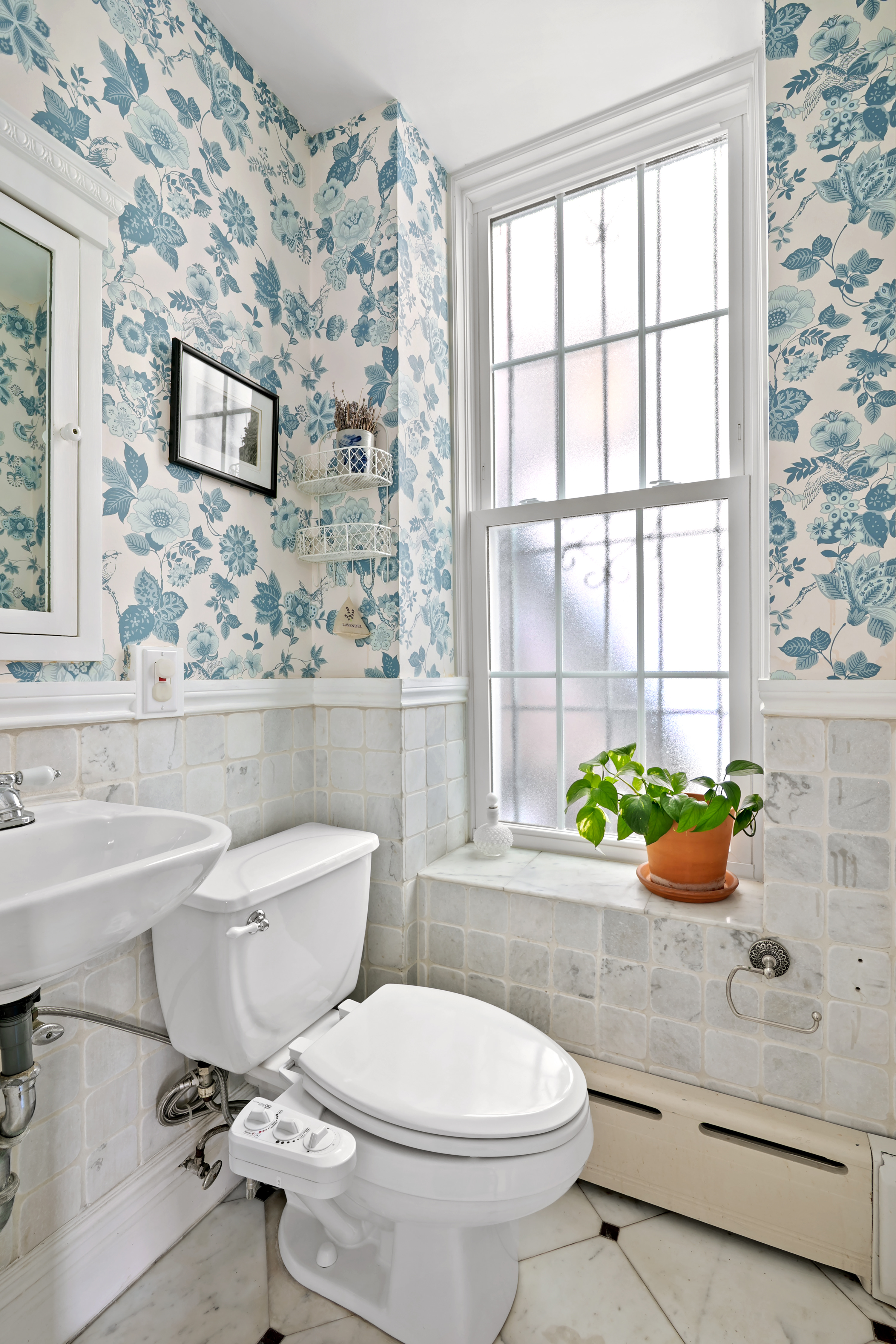 41-27 39th Place Queens, NY 11104 - Photo 7 of 13 a bathroom with a toilet sink and mirror