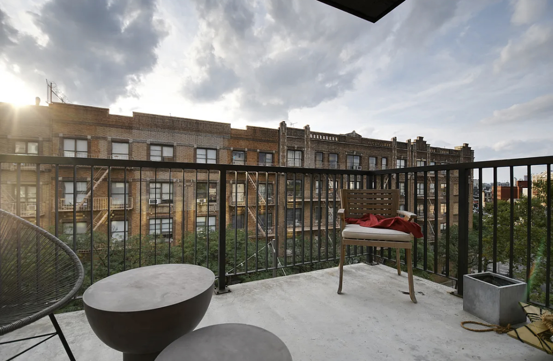 281 Union Avenue, Unit PHJ Brooklyn, NY 11211 - Photo 7 of 8 a view of a balcony with chair and potted plant