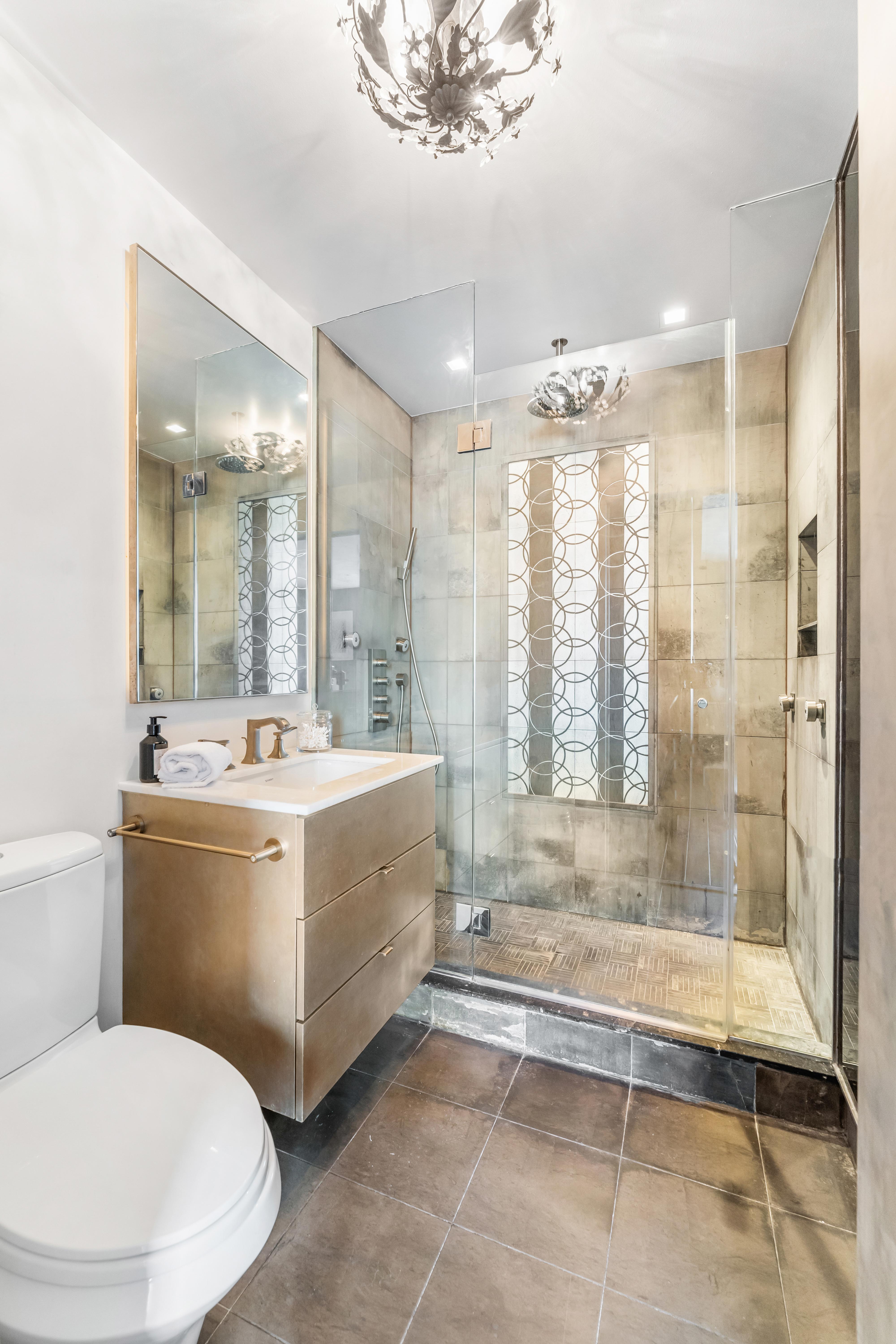 400 East 90th Street, Unit 23B Manhattan, NY 10128 - Photo 11 of 17 a bathroom with a granite countertop sink mirror bathtub and toilet