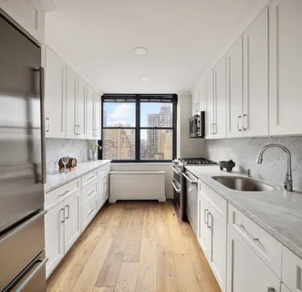 a kitchen with a sink a window and appliances