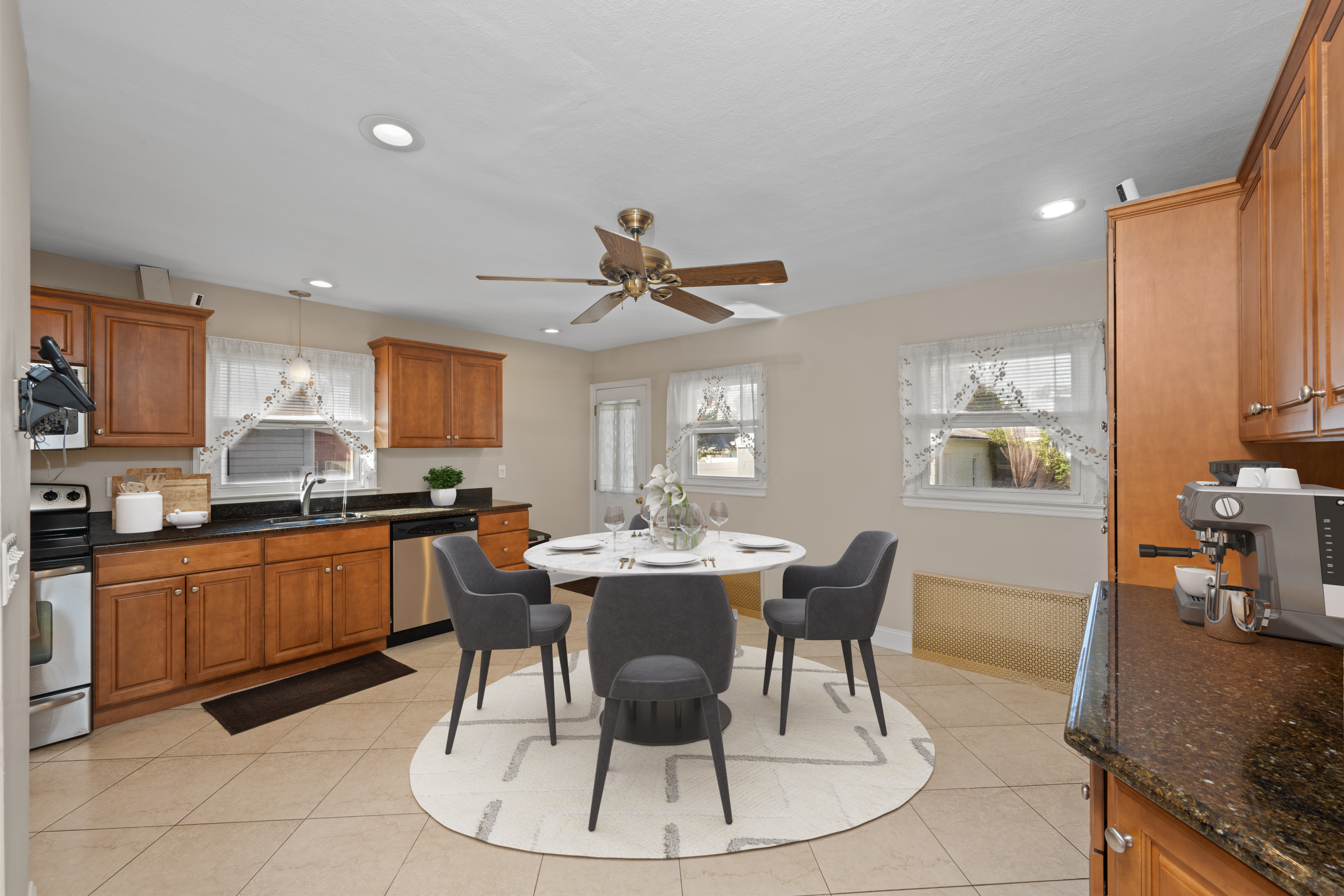 522 Stewart Avenue Staten Island, NY 10314 - Photo 11 of 33 a kitchen with stainless steel appliances granite countertop a sink a stove a dining table and chairs