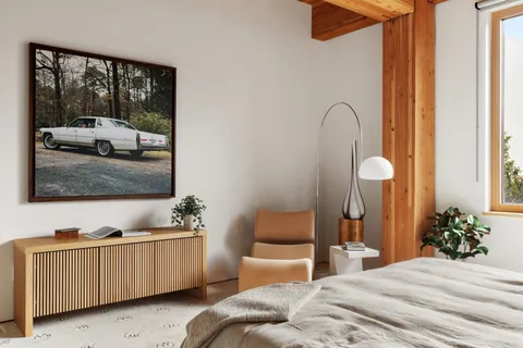 a bedroom with a bed and a dresser with mirror