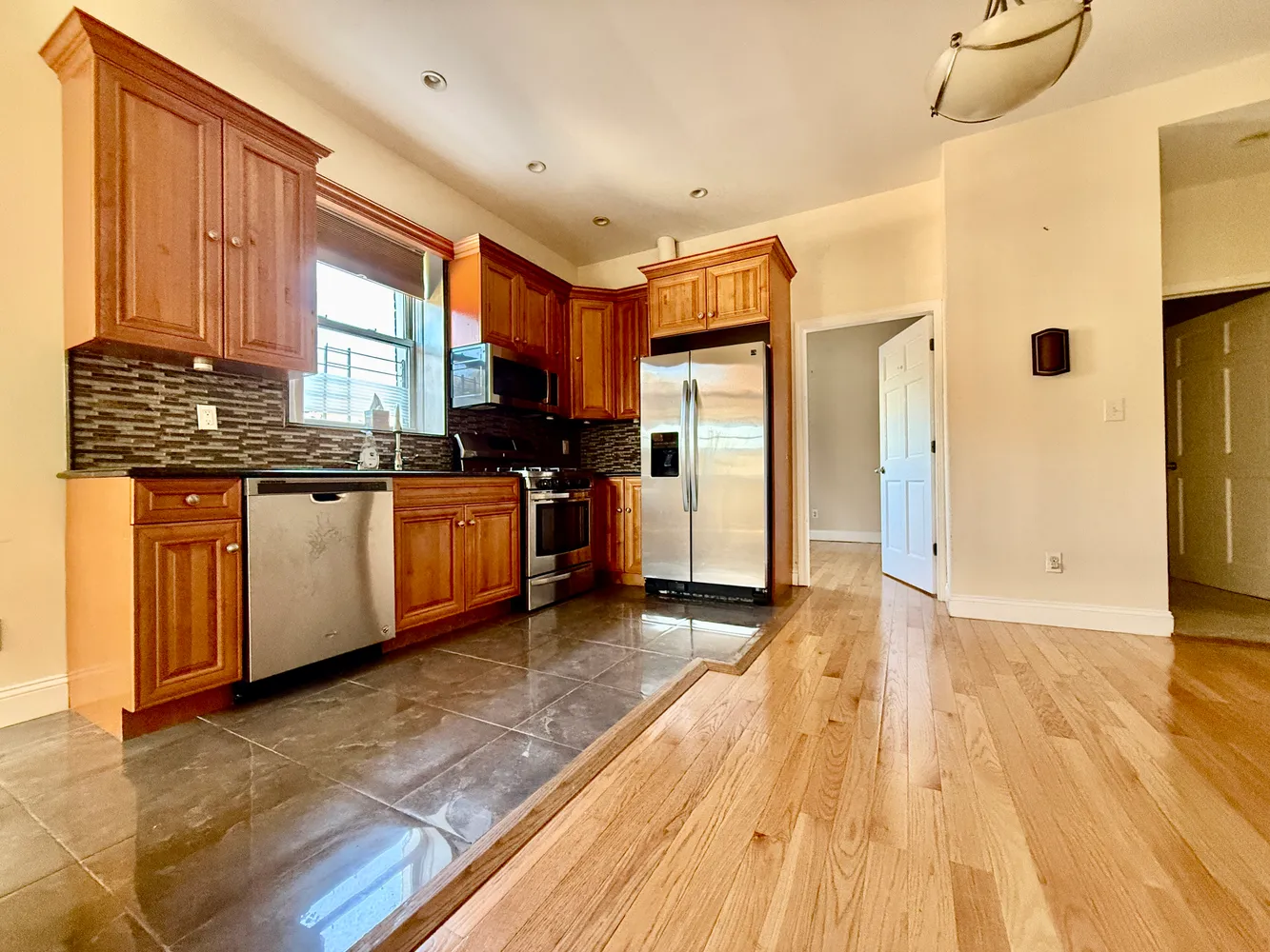 a kitchen with stainless steel appliances granite countertop a stove and a refrigerator