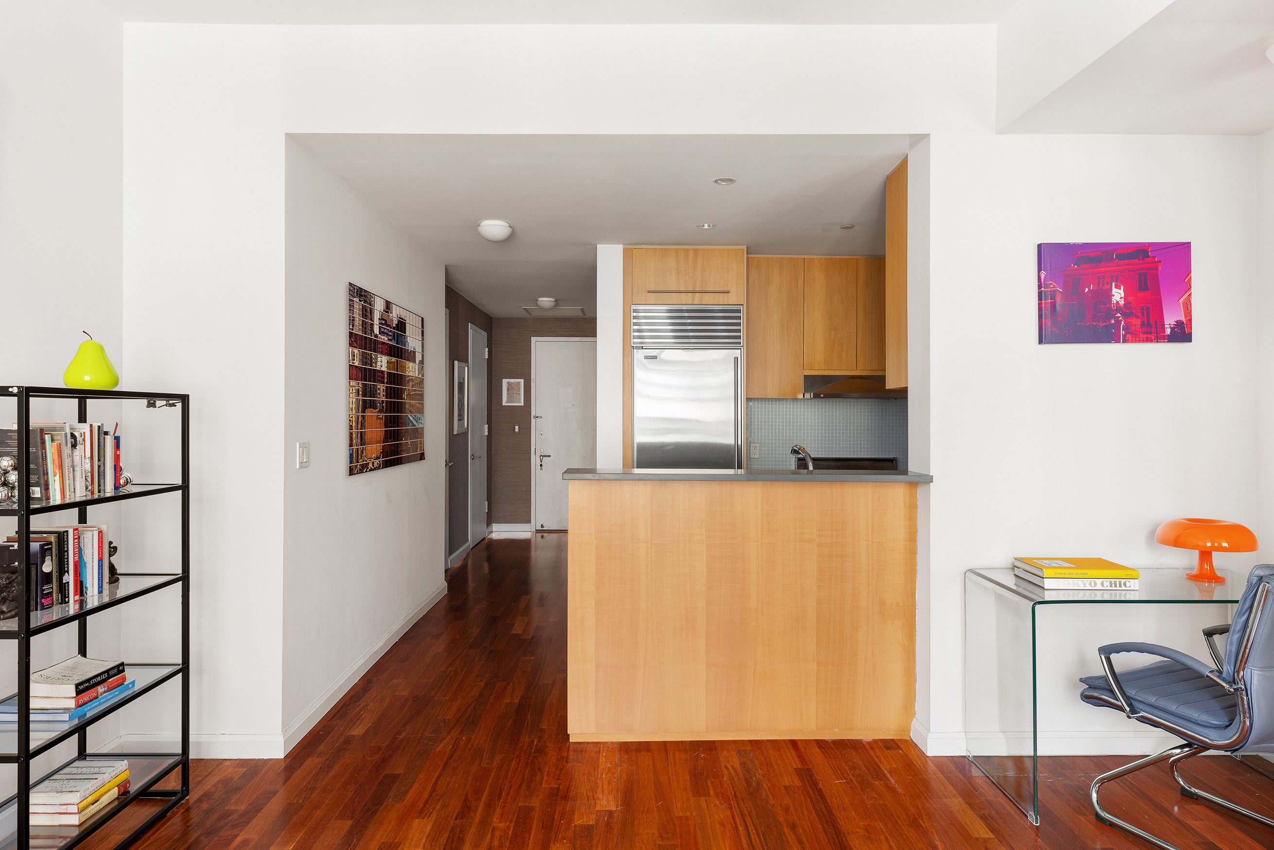255 Hudson Street, Unit 6F Manhattan, NY 10013 - Photo 2 of 7 a view of a hallway with wooden floor and furniture