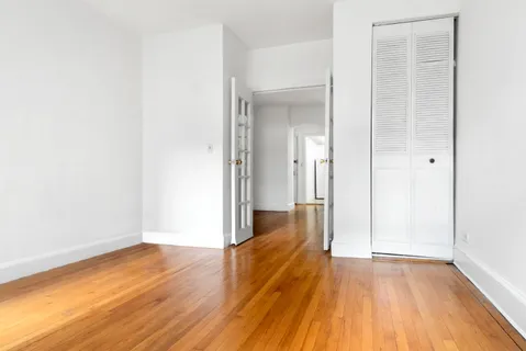 a view of a room with wooden floor