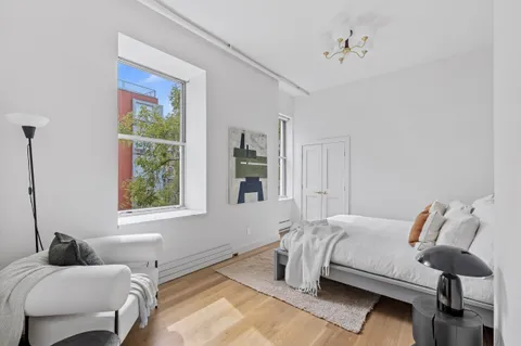 a bedroom with a bed and window