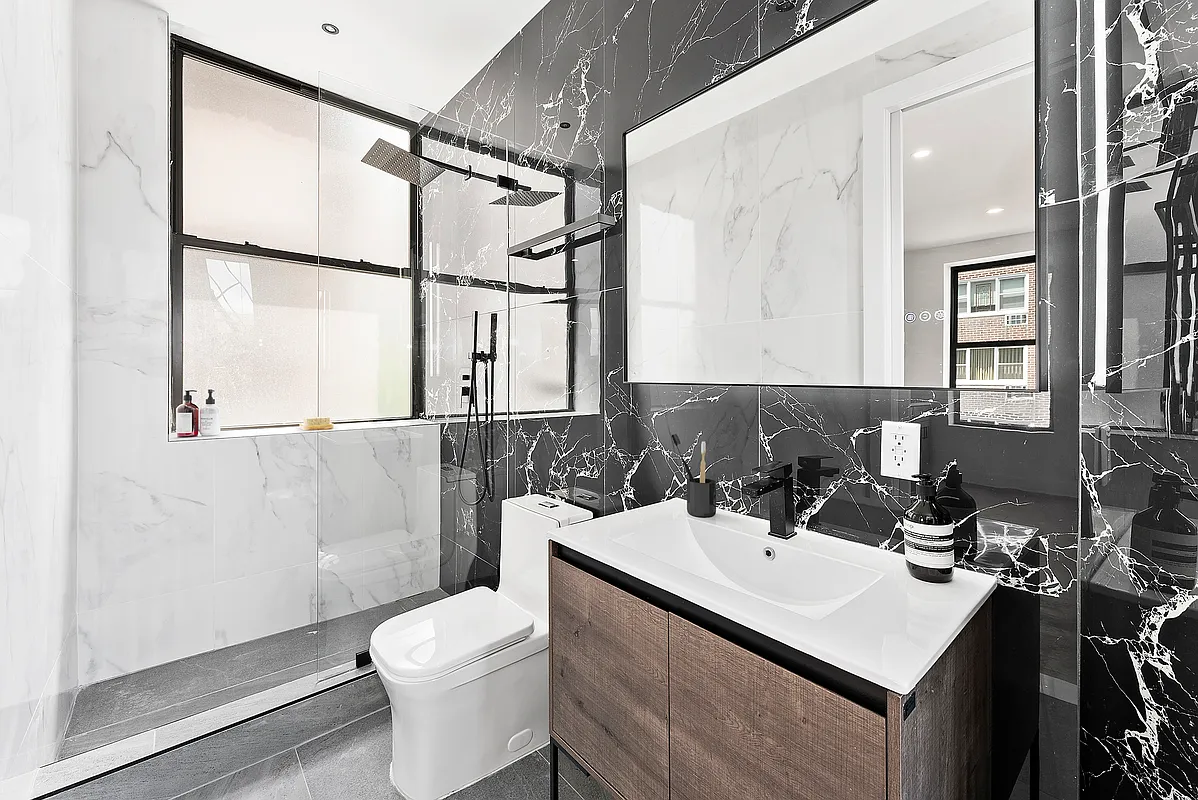 16 Barrow Street, Unit 3A Manhattan, NY 10014 - Photo 3 of 6 a bathroom with a sink toilet and shower