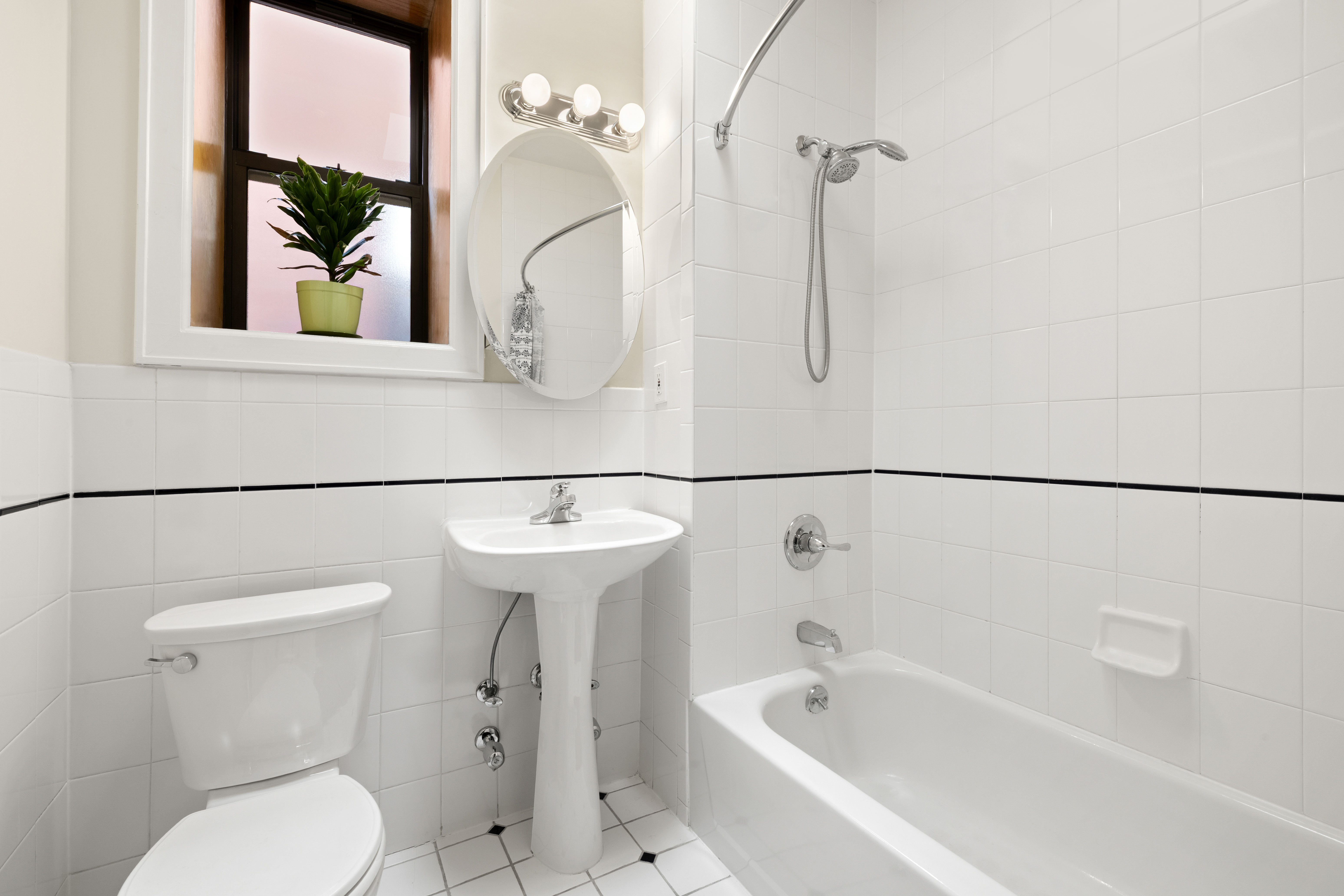 370 St Nicholas Avenue, Unit PH5B Manhattan, NY 10027 - Photo 7 of 12 a bathroom with a sink a toilet and shower