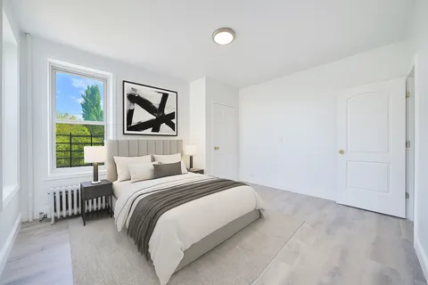 a bedroom with a bed and a window