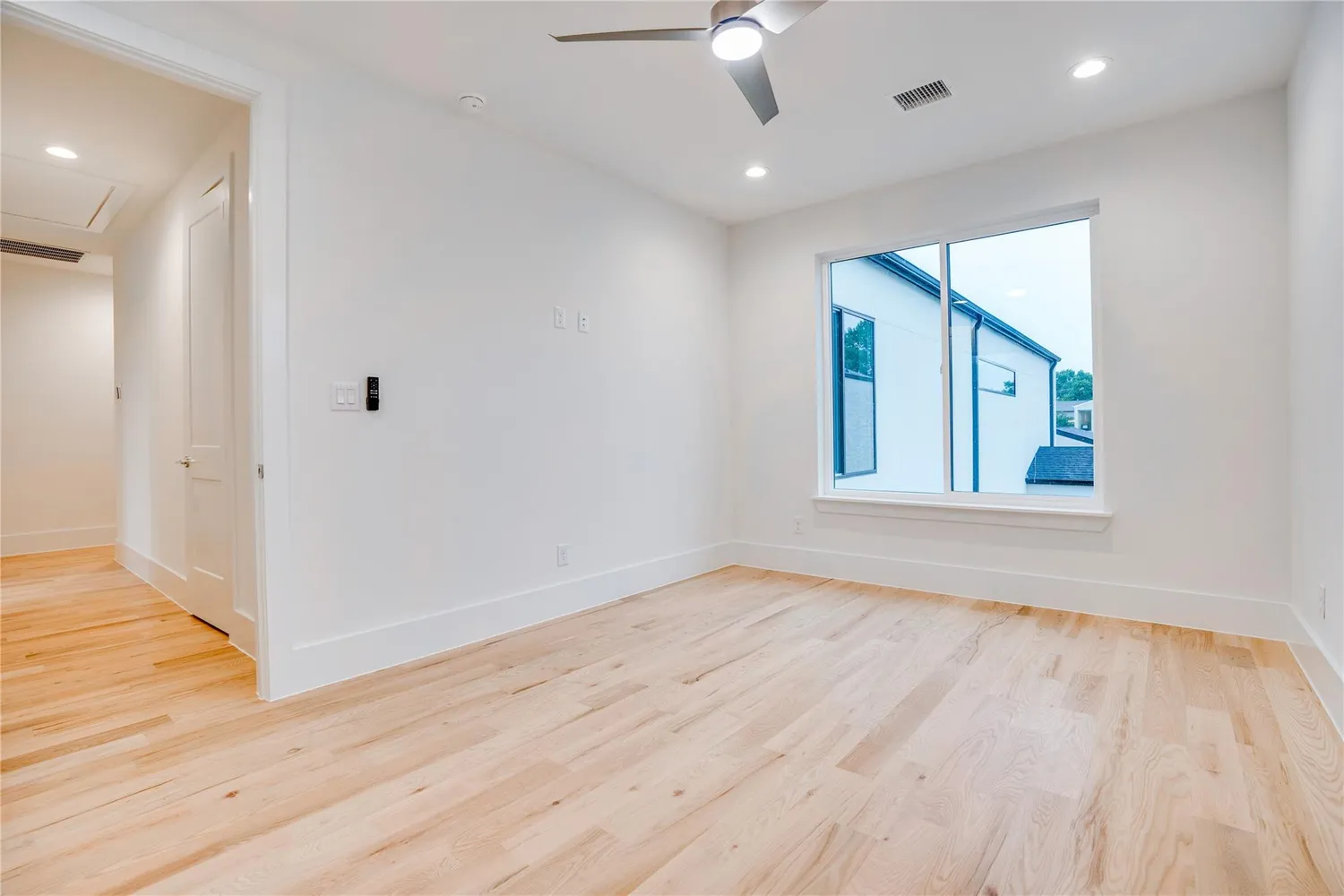 wooden floor in an empty room with a window