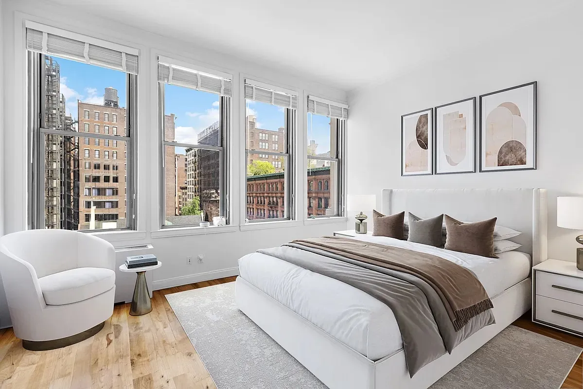 a bedroom with a bed and glass window