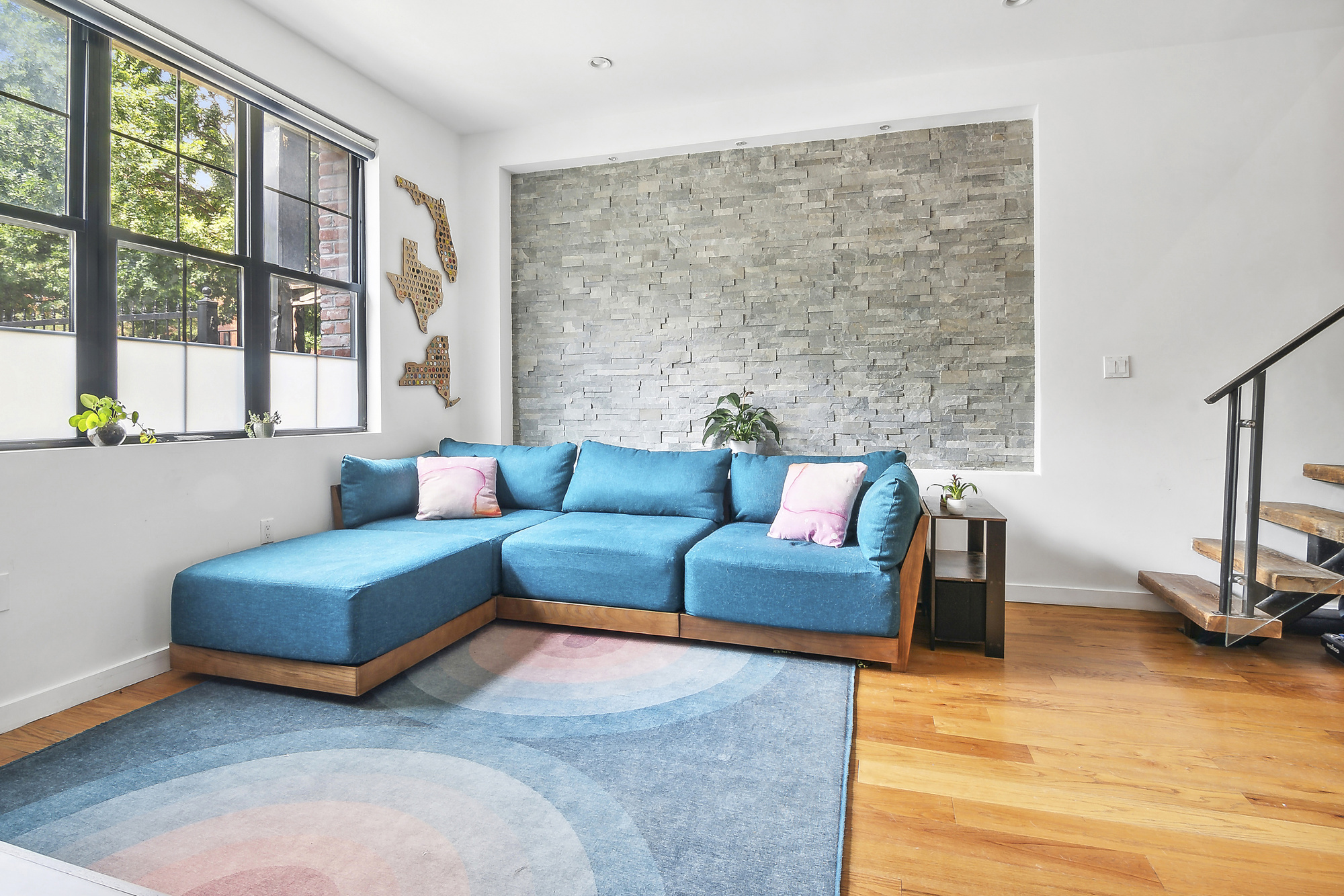 449 Evergreen Avenue, Unit 1 Brooklyn, NY 11221 - Photo 3 of 10 a living room with furniture and a floor to ceiling window
