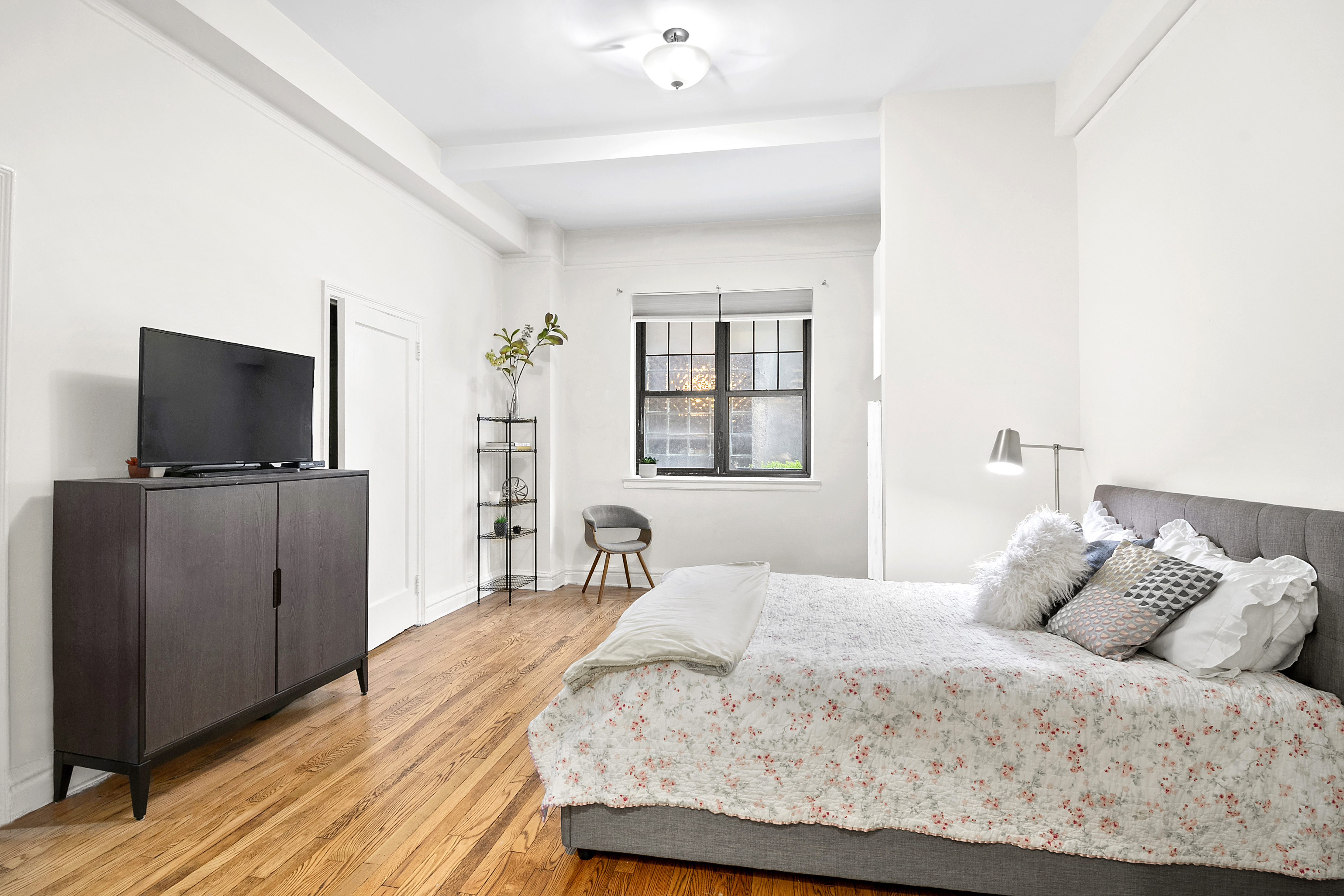 200 East 16th Street, Unit 1C Manhattan, NY 10003 - Photo 1 of 9 a bedroom with a bed and a flat screen tv