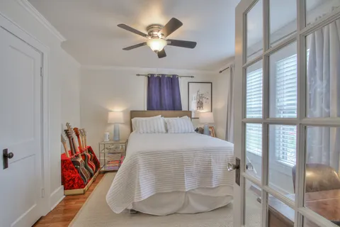 a bedroom with a large bed and a chandelier
