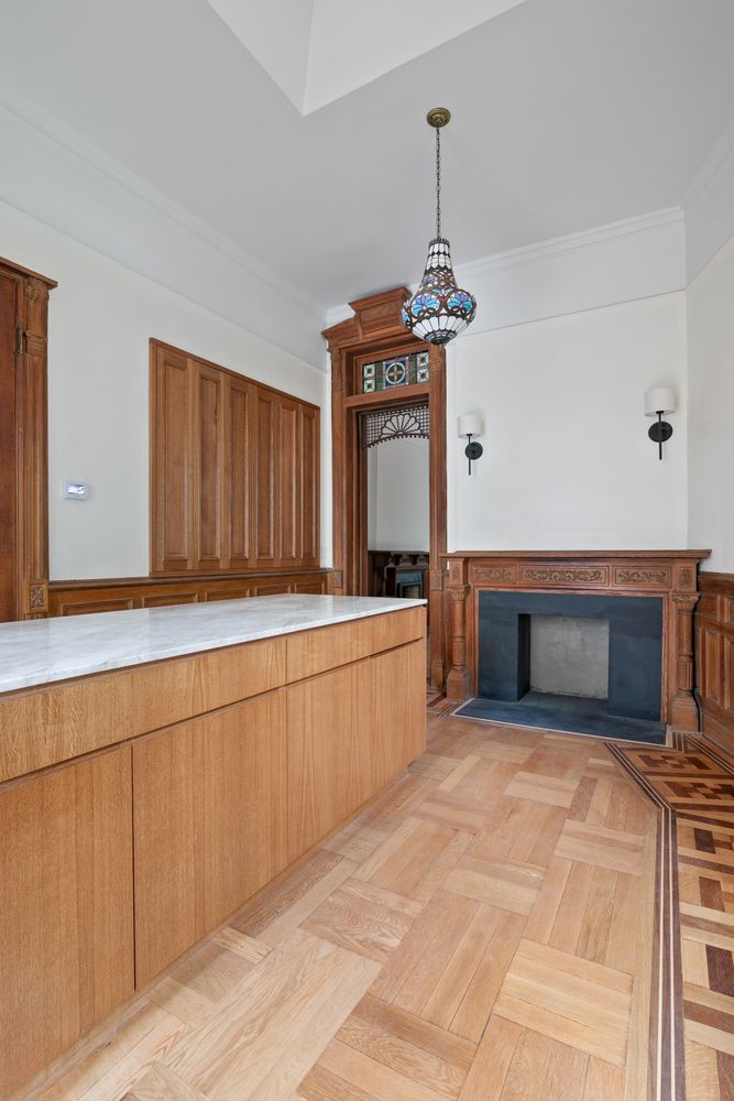 a bedroom with a bed couch and windows