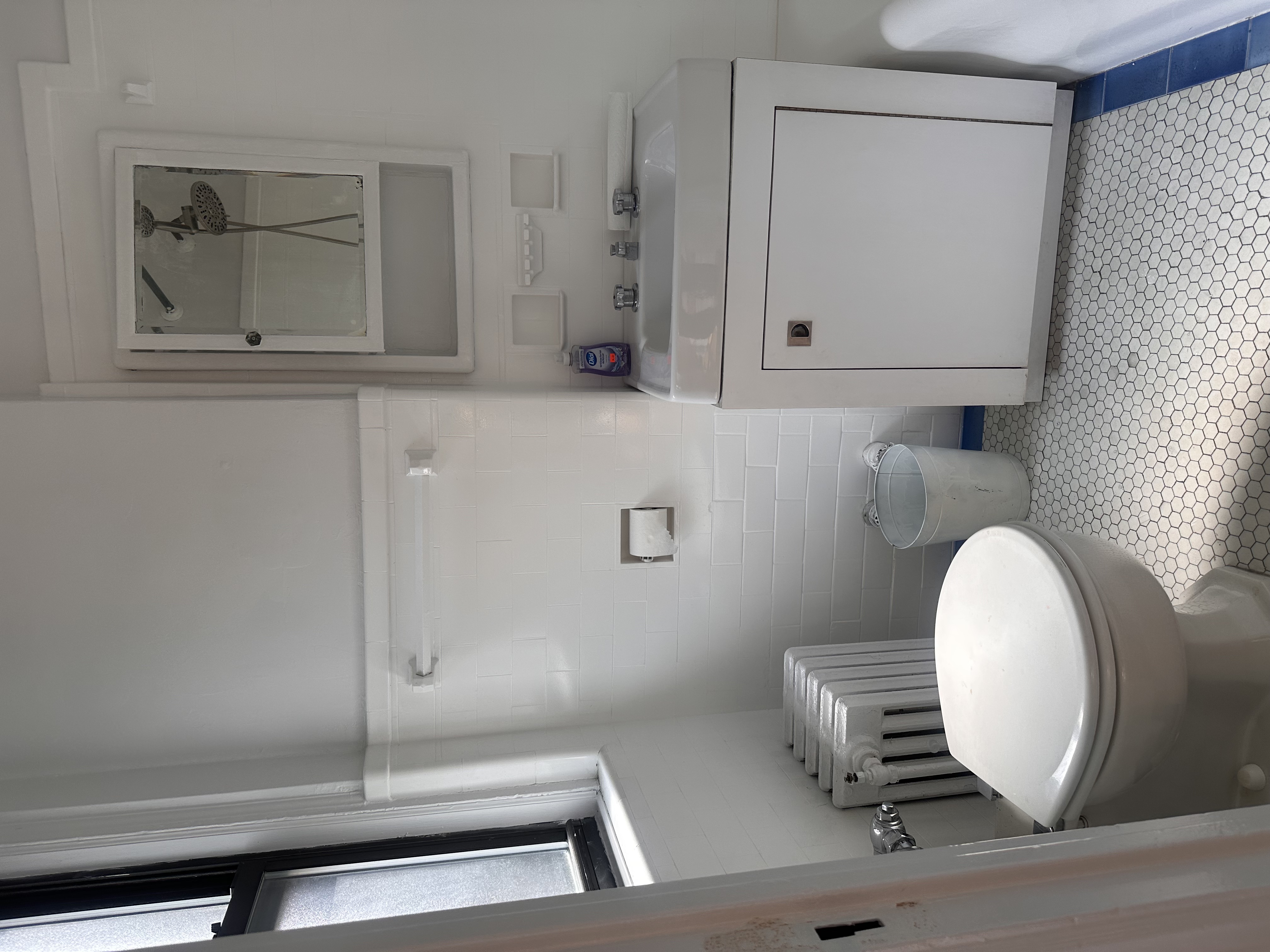 457 West 57th Street, Unit 505 Manhattan, NY 10019 - Photo 9 of 10 a bathroom with a toilet a sink and mirror