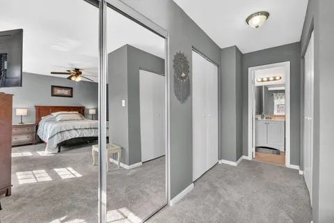 a bathroom with a granite countertop sink toilet a mirror and shower