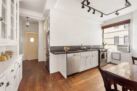 a open kitchen with sink cabinets and wooden floor