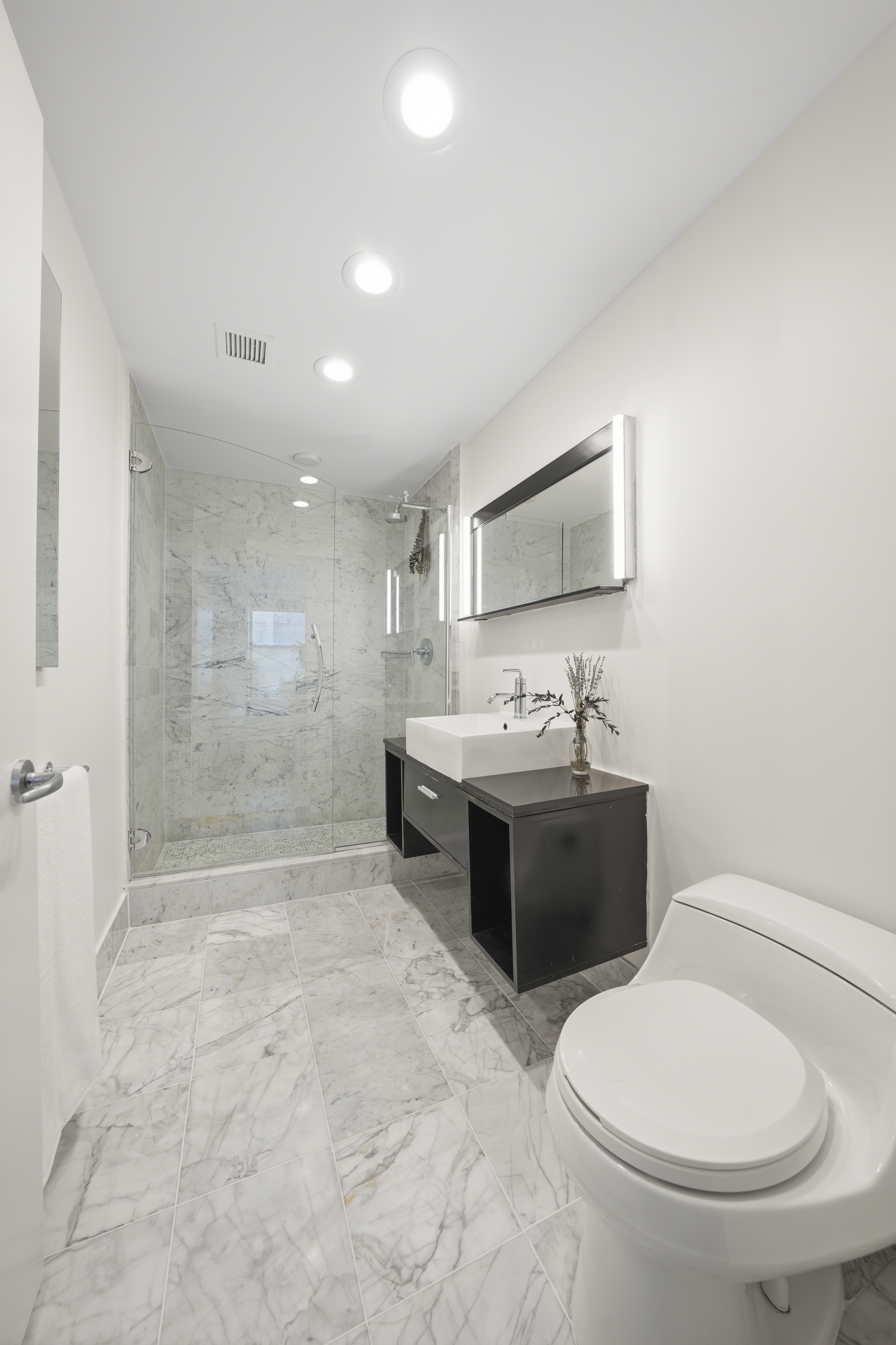 257 West 117th Street, Unit 2F Manhattan, NY 10026 - Photo 13 of 21 a bathroom with a sink a toilet and shower
