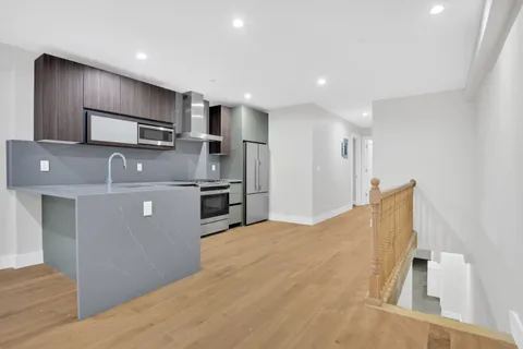 a kitchen with stainless steel appliances granite countertop a refrigerator sink and microwave