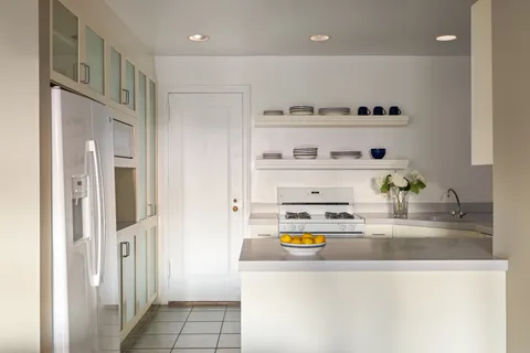 a kitchen with stainless steel appliances granite countertop a refrigerator and a stove