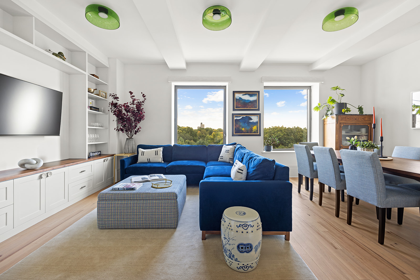 a living room with furniture a window and a flat screen tv