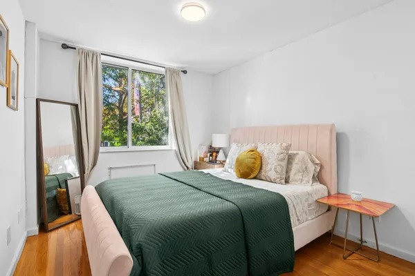 a bedroom with a bed and a window