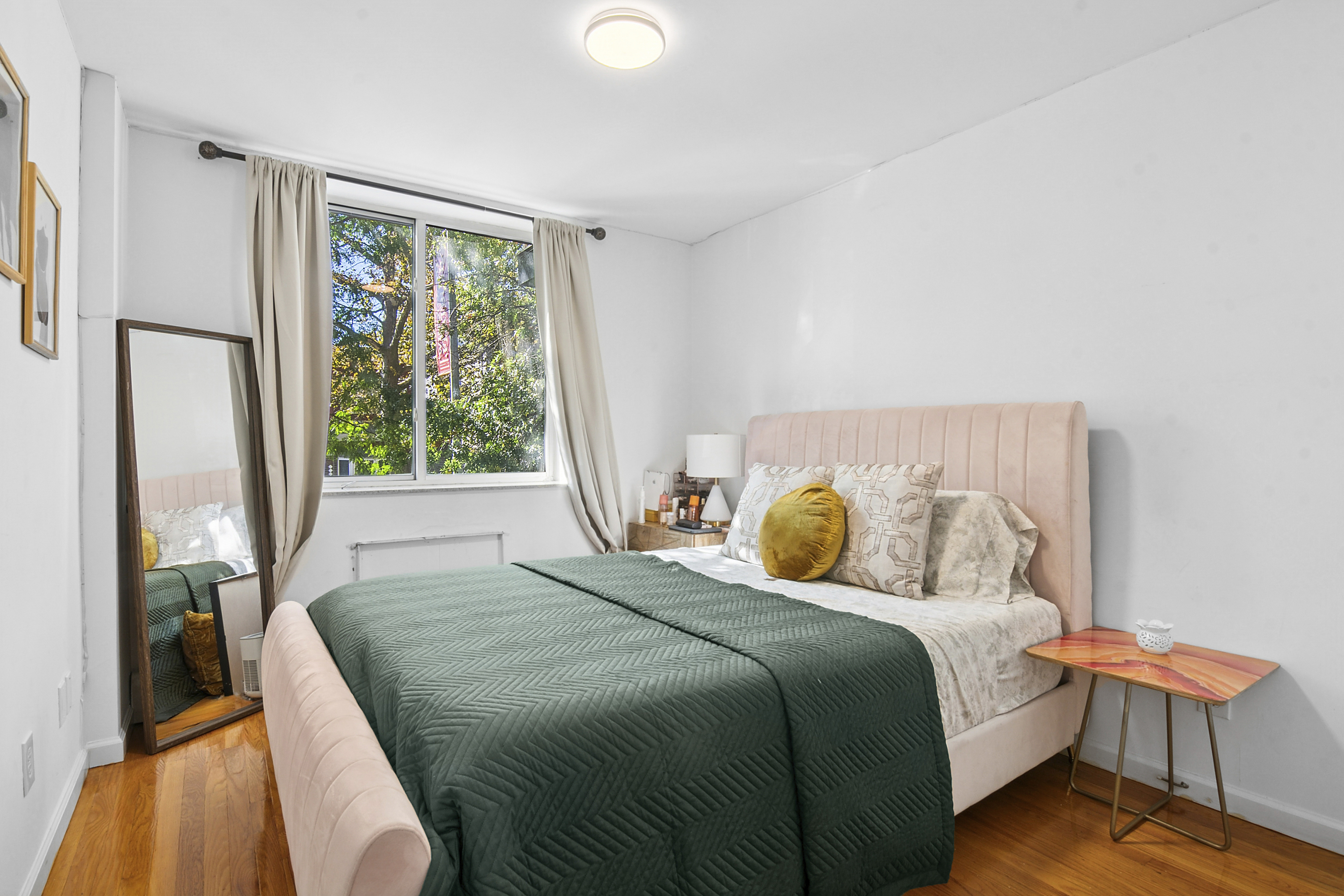 145 Kenilworth Place, Unit 2A Brooklyn, NY 11210 - Photo 5 of 7 a bedroom with a bed and a window