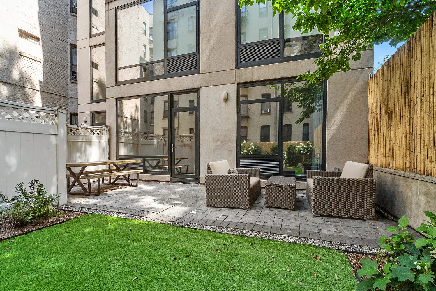 a view of patio with couches table and chairs and potted plants