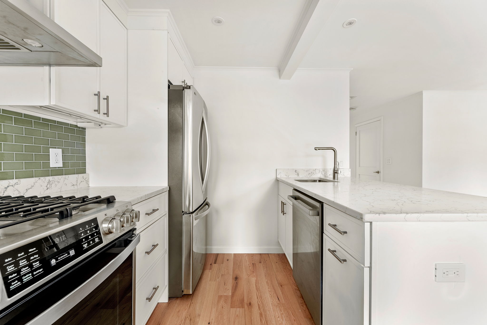 54 East 4th Street, Unit 1 Brooklyn, NY 11218 - Photo 4 of 12 a kitchen with stainless steel appliances granite countertop a stove and a refrigerator