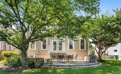 a front view of a house with a yard table and chairs
