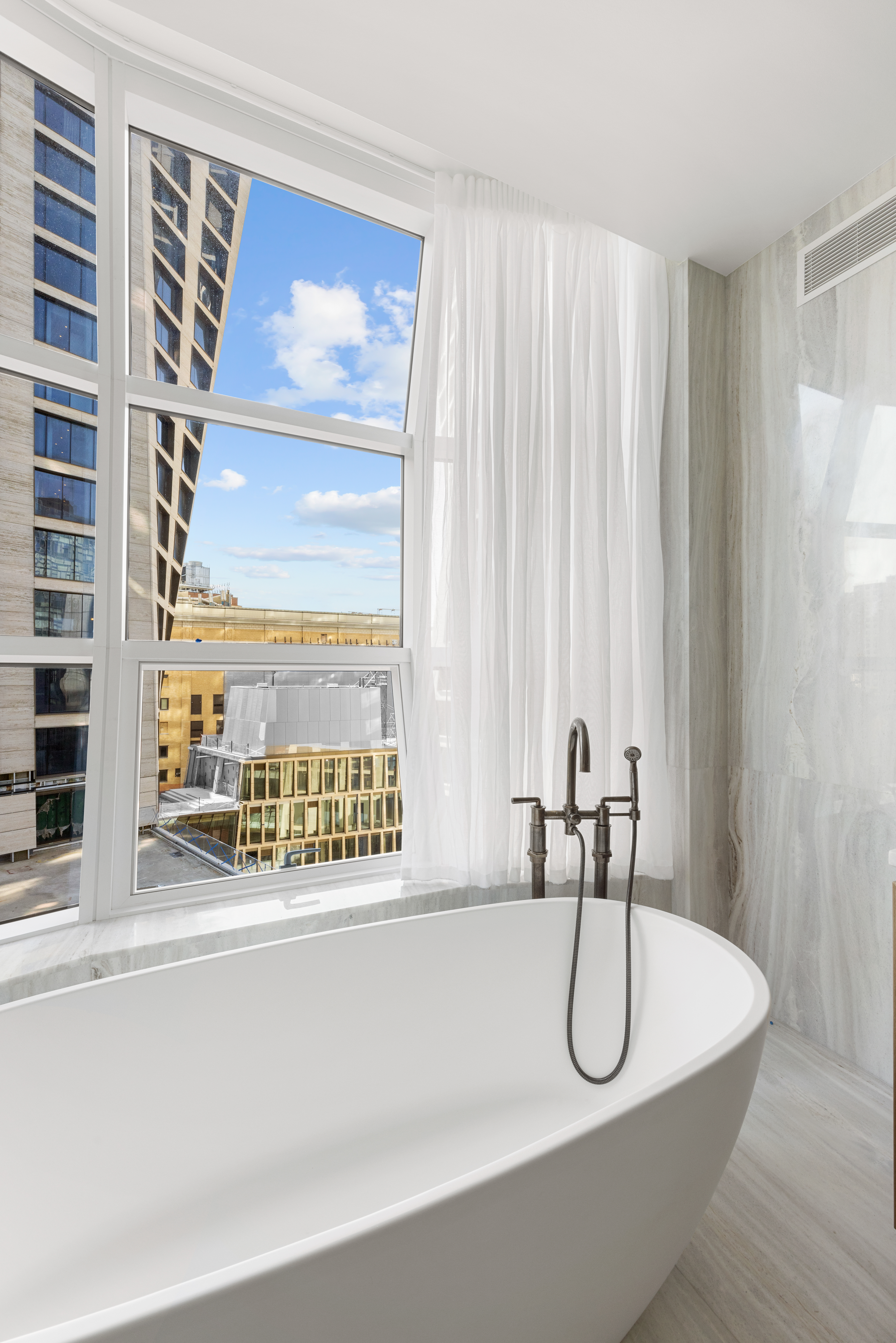 515 West 18th Street, Unit 1010 Manhattan, NY 10011 - Photo 10 of 19 a bathroom with a tub and a large window